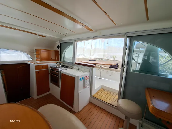 Tortuga Yacht Photos Pics Interior of 2001 Lagoon 380 catamaran with kitchen and seating area.