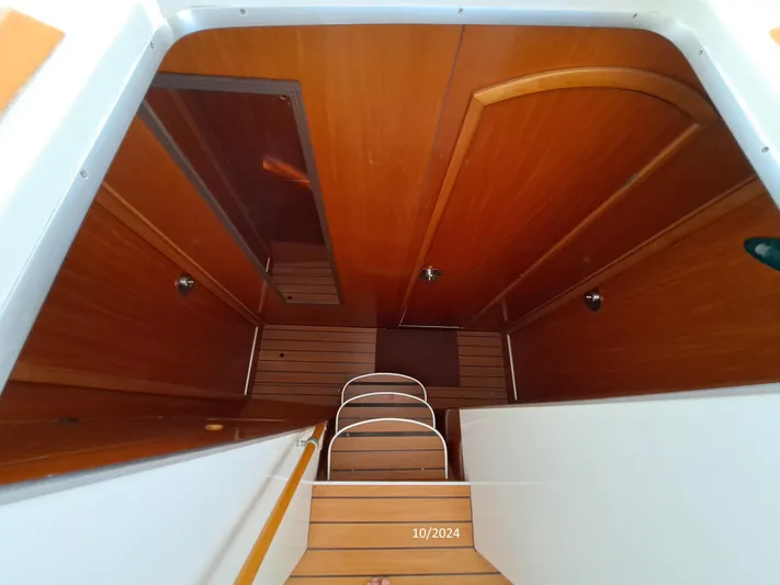 Tortuga Yacht Photos Pics Interior view of a 2001 Lagoon 380 catamaran with wooden paneling and steps.