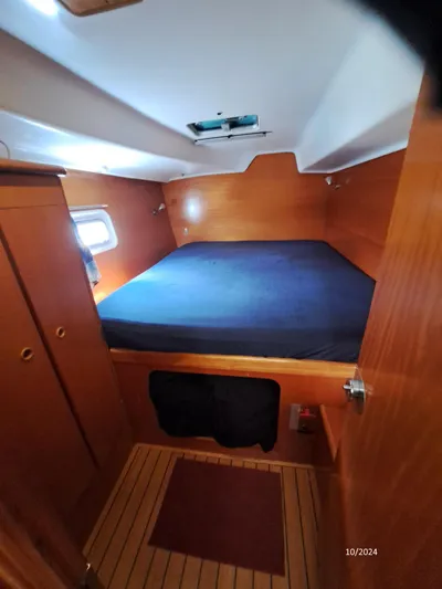 Tortuga Yacht Photos Pics Interior cabin of 2001 Lagoon 380 catamaran with wooden finish and cozy bed.