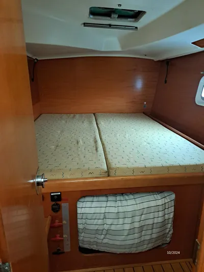 Tortuga Yacht Photos Pics Cabin interior of 2001 Lagoon 380 catamaran with double bed and wooden finish.