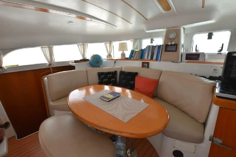 Tortuga Yacht Photos Pics Interior of 2001 Lagoon 380 catamaran with cozy seating and nautical decor.