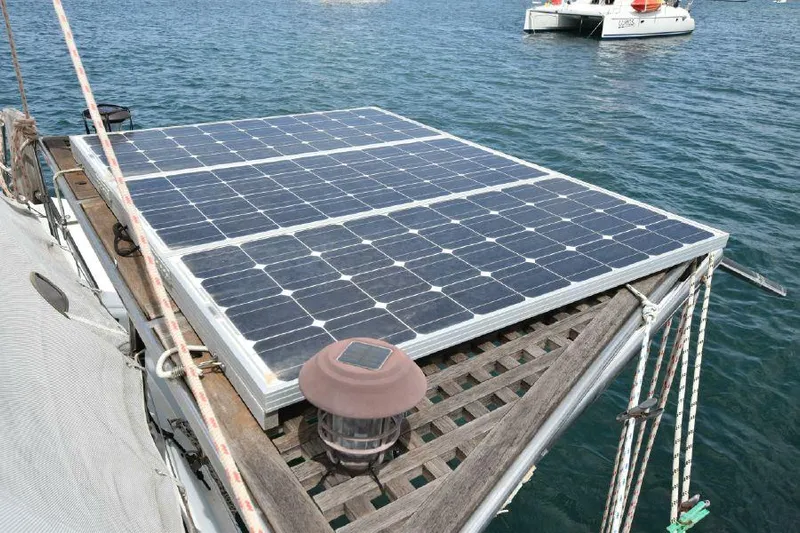 Tortuga Yacht Photos Pics Solar panels on a 2001 Lagoon 380 catamaran, floating on water.