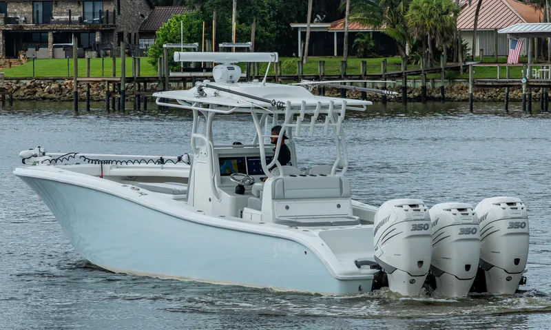  Yacht Photos Pics 2018 Yellowfin 36 Offshore boat with triple Mercury engines on a calm waterway.