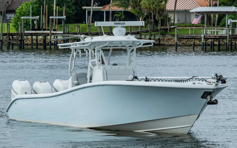  Yacht Photos Pics 2018 Yellowfin 36 Offshore boat on calm water near docks.