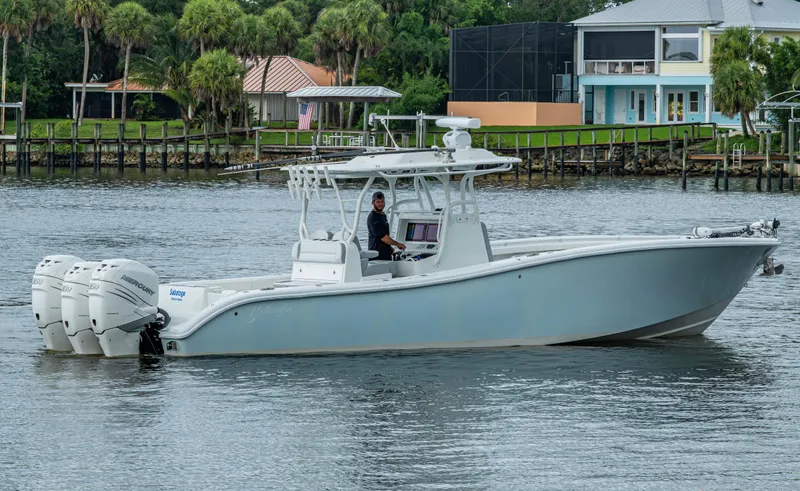  Yacht Photos Pics 2018 Yellowfin 36 Offshore boat with triple Mercury engines on a calm waterway.