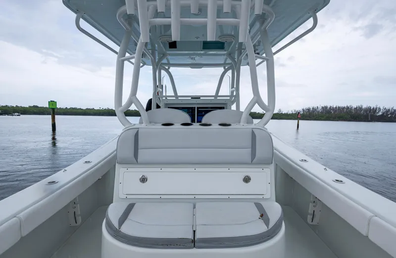  Yacht Photos Pics 2018 Yellowfin 36 Offshore boat interior with seating, on calm water, overcast sky.