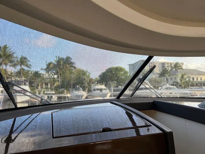 The Best Day Ever Yacht Photos Pics Interior view from a 2013 Prestige 500 S yacht, overlooking a marina with palm trees.