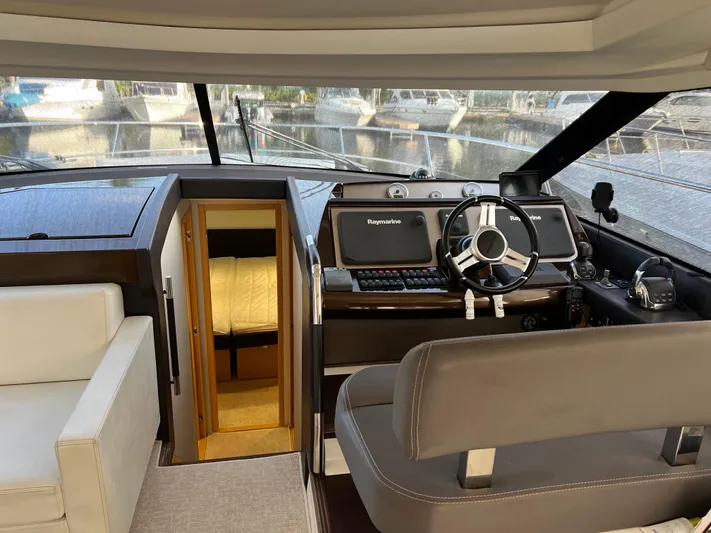 The Best Day Ever Yacht Photos Pics Interior of 2013 Prestige 500 S yacht, featuring helm, steering wheel, and cabin entrance.