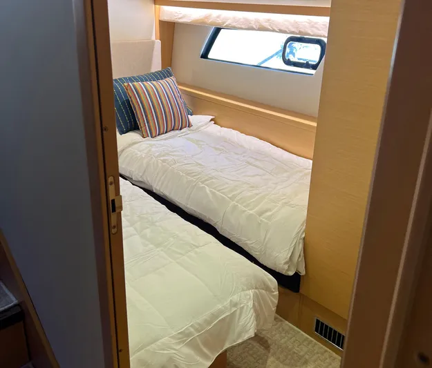 The Best Day Ever Yacht Photos Pics Cabin interior of 2013 Prestige 500 S yacht with twin beds and striped pillows.