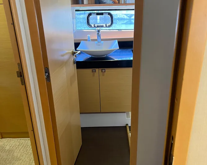 The Best Day Ever Yacht Photos Pics Bathroom interior of 2013 Prestige 500 S yacht with modern sink and wooden cabinetry.