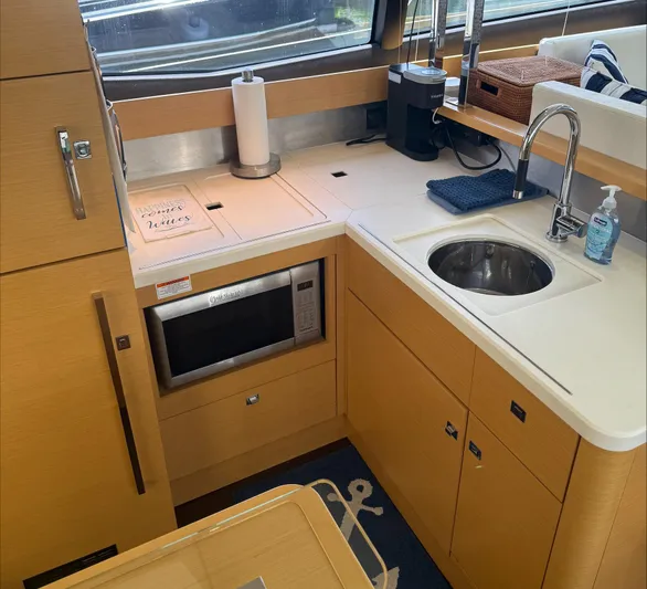 The Best Day Ever Yacht Photos Pics Modern kitchen in 2013 Prestige 500 S yacht with microwave, sink, and wooden cabinetry.