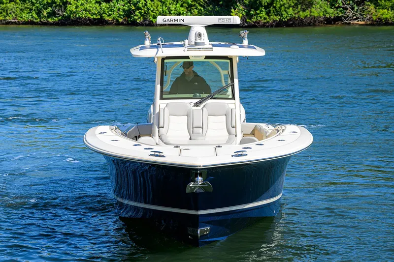 W/seakeeper Yacht Photos Pics 2023 Scout 355 LXF boat cruising on a calm blue waterway.