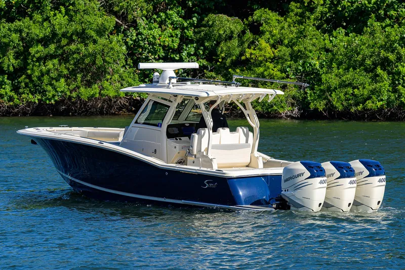 W/seakeeper Yacht Photos Pics 2023 Scout 355 LXF boat with triple outboard engines on a scenic waterway.