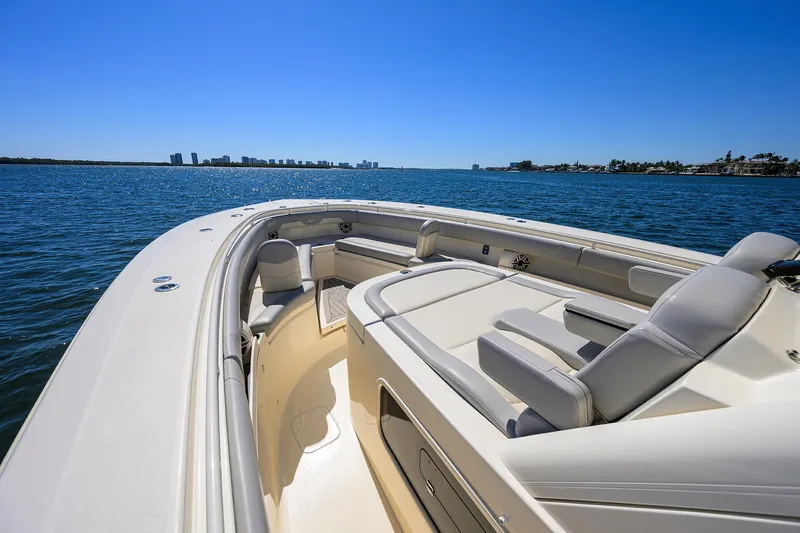 W/seakeeper Yacht Photos Pics 2023 Scout 355 LXF boat on calm water with city skyline in background.