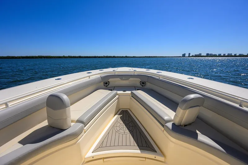 W/seakeeper Yacht Photos Pics 2023 Scout 355 LXF boat, spacious seating, open water view, clear blue sky.