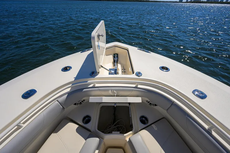 W/seakeeper Yacht Photos Pics 2023 Scout 355 LXF boat bow with seating and storage, on calm water.