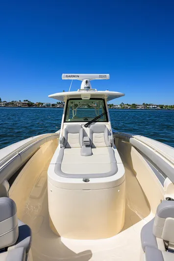 W/seakeeper Yacht Photos Pics 2023 Scout 355 LXF boat on water, clear sky, luxurious seating.
