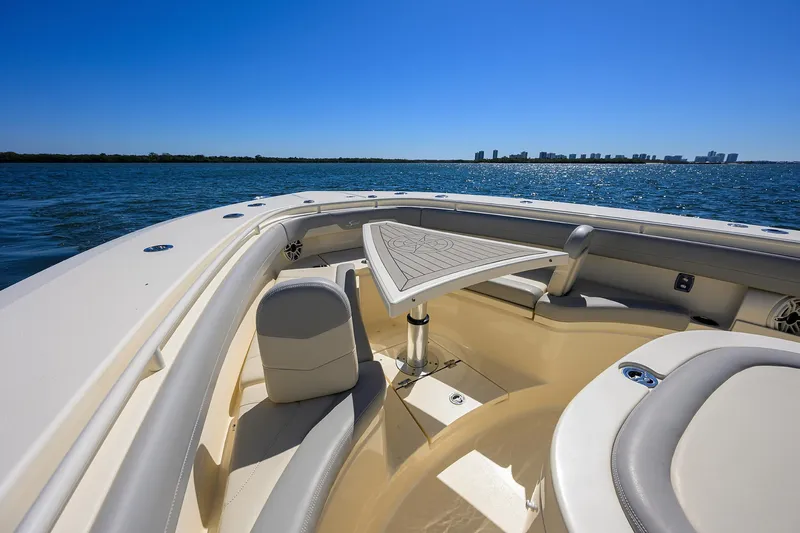 W/seakeeper Yacht Photos Pics 2023 Scout 355 LXF boat interior with seating and table, on open water.