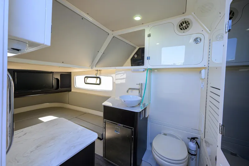 W/seakeeper Yacht Photos Pics 2023 Scout 355 LXF interior with modern bathroom and seating area.