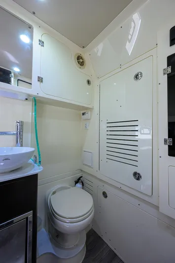 W/seakeeper Yacht Photos Pics 2023 Scout 355 LXF boat bathroom interior with modern fixtures and storage cabinets.