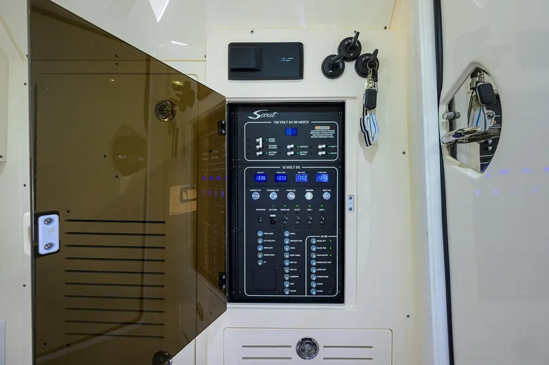 W/seakeeper Yacht Photos Pics 2023 Scout 355 LXF electrical panel with open cover, showcasing controls and switches.