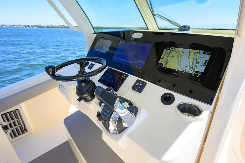 W/seakeeper Yacht Photos Pics 2023 Scout 355 LXF helm with advanced navigation displays on open water.