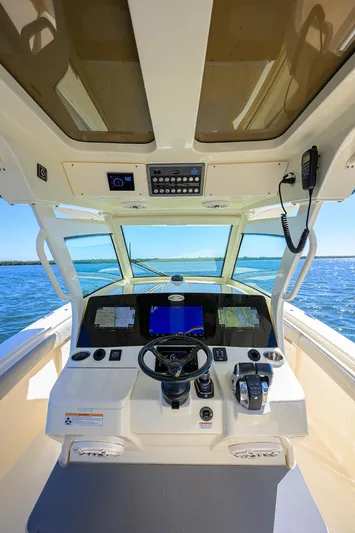W/seakeeper Yacht Photos Pics 2023 Scout 355 LXF boat cockpit with advanced navigation system and ocean view.