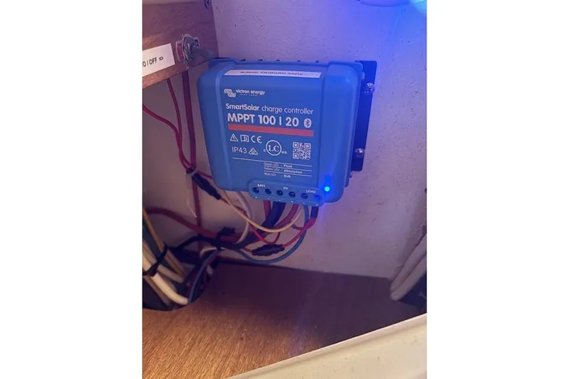  Yacht Photos Pics SmartSolar charge controller in 2004 Soubise Plaisance Freydis 46 yacht, blue casing, wiring visible.