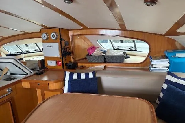  Yacht Photos Pics Interior of 2004 Soubise Plaisance Freydis 46 yacht with wooden finish and seating area.
