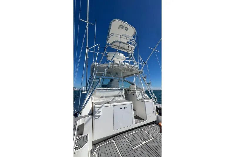 Clean Fun Yacht Photos Pics 2005 Rampage 38 Express boat with tower, viewed from the rear on open water.