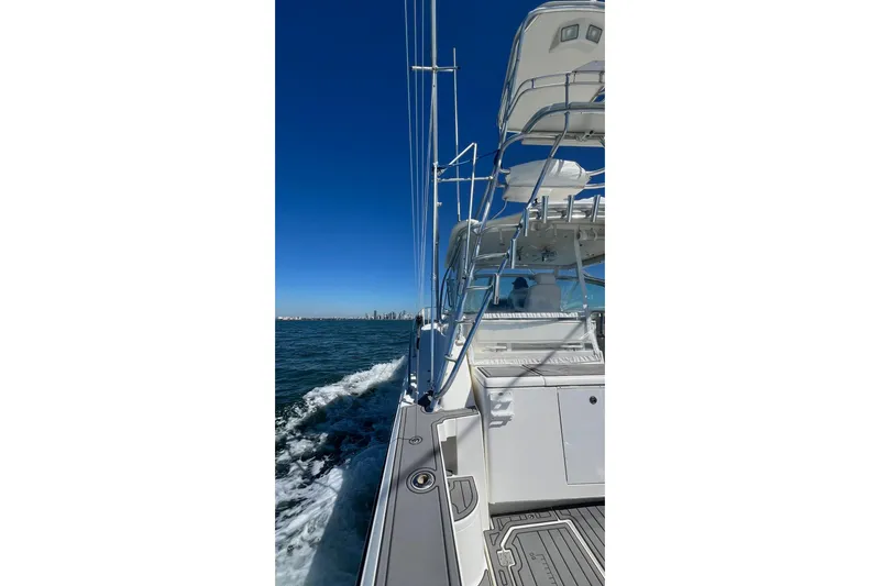 Clean Fun Yacht Photos Pics 2005 Rampage 38 Express yacht cruising on open water under clear blue sky.