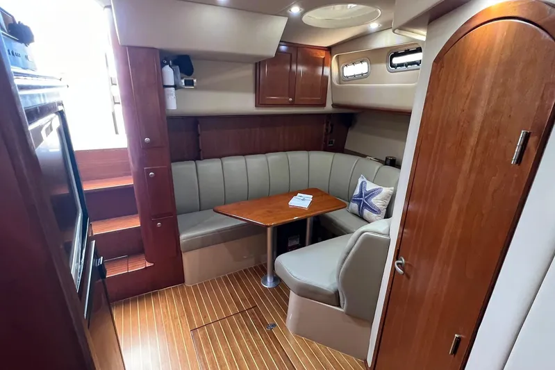 Clean Fun Yacht Photos Pics Luxurious interior of 2005 Rampage 38 Express yacht with wood finishes and cozy seating.