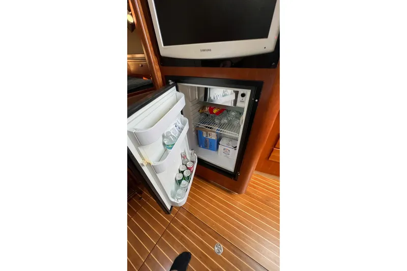 Clean Fun Yacht Photos Pics Mini fridge stocked with drinks inside a 2005 Rampage 38 Express boat cabin.