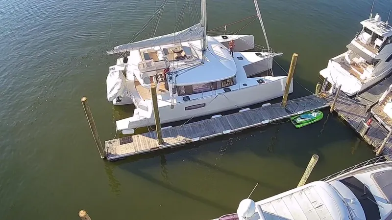 Tri It Yacht Photos Pics Aerial view of a 2018 NEEL 51 trimaran docked at a marina.