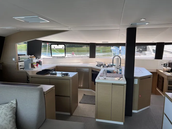 Tri It Yacht Photos Pics Modern kitchen interior on 2018 NEEL 51 yacht, featuring sleek countertops and ample natural light.