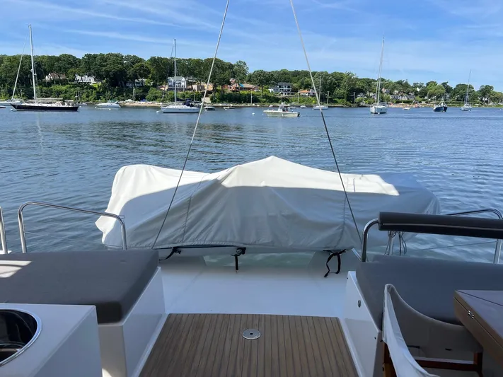 Tri It Yacht Photos Pics NEEL 51 trimaran deck overlooking serene waters and distant sailboats, 2018 model.