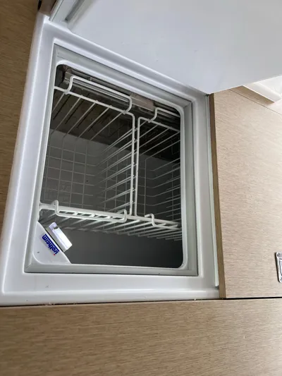 Tri It Yacht Photos Pics Empty freezer compartment in a 2018 NEEL 51 model, featuring wire shelving.