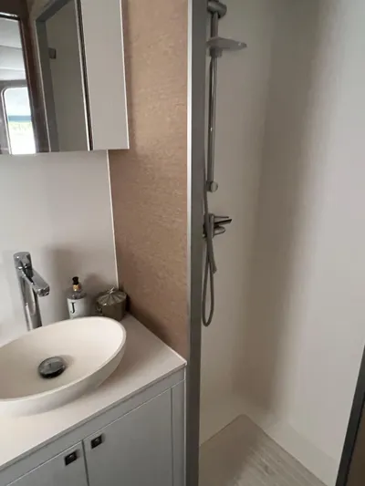 Tri It Yacht Photos Pics Modern bathroom with sleek sink and shower in a 2018 NEEL 51 model.