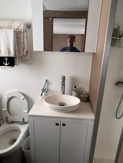 Tri It Yacht Photos Pics Modern bathroom in a 2018 NEEL 51, featuring a sink, mirror, and toilet.