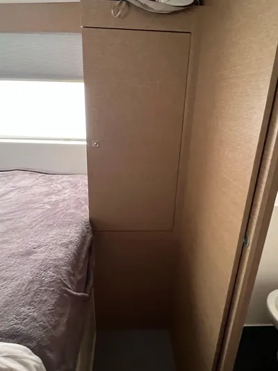 Tri It Yacht Photos Pics Interior of a 2018 NEEL 51, featuring a cozy bedroom with wooden cabinetry.