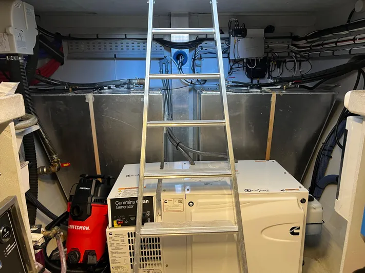 Tri It Yacht Photos Pics Engine room of a 2018 NEEL 51 with ladder, generator, and wiring.