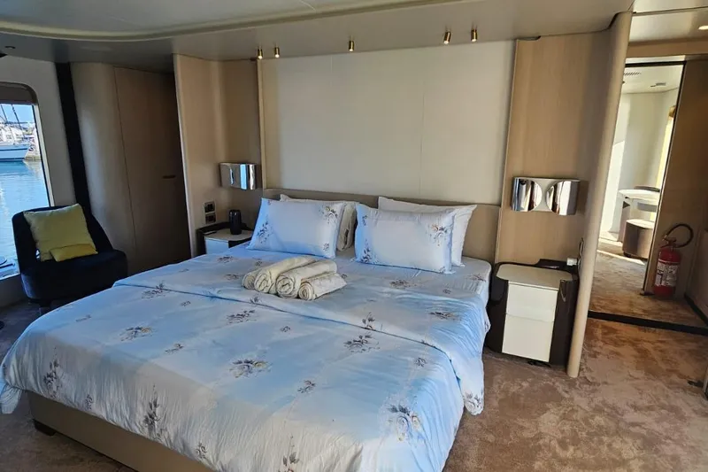  Yacht Photos Pics Luxurious bedroom interior of 2022 Azimut Grande 32 Metri yacht with elegant decor and sea view.