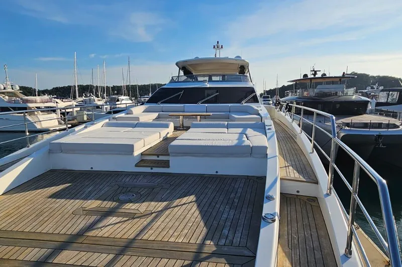  Yacht Photos Pics Luxurious 2022 Azimut Grande 32 Metri yacht with spacious deck and sun loungers in marina.