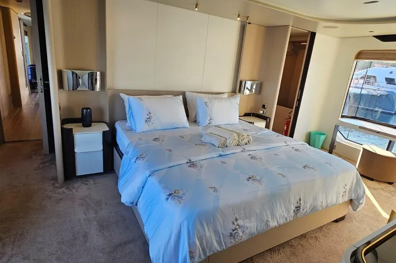  Yacht Photos Pics Luxurious bedroom interior on 2022 Azimut Grande 32 Metri yacht, featuring elegant bedding and modern decor.