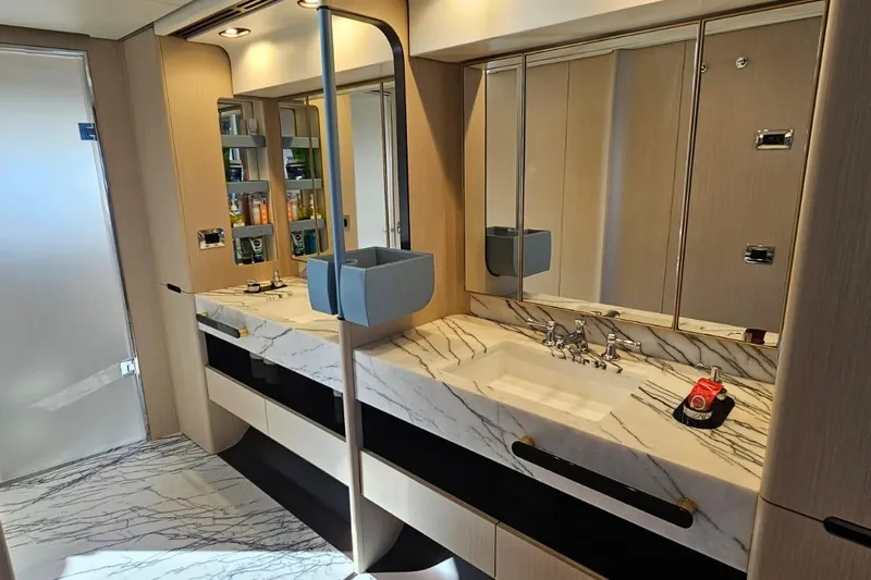  Yacht Photos Pics Luxurious bathroom in 2022 Azimut Grande 32 Metri yacht with marble countertops and modern fixtures.