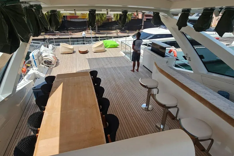  Yacht Photos Pics Luxurious Azimut Grande 32 Metri yacht deck with dining area and bar, 2022 model.