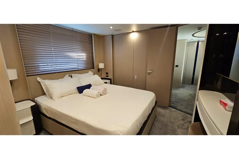  Yacht Photos Pics Luxurious bedroom interior of 2022 Azimut Grande 32 Metri yacht, featuring elegant design and cozy ambiance.