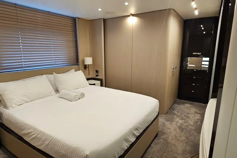  Yacht Photos Pics Luxurious bedroom interior of 2022 Azimut Grande 32 Metri yacht, featuring elegant design and cozy ambiance.