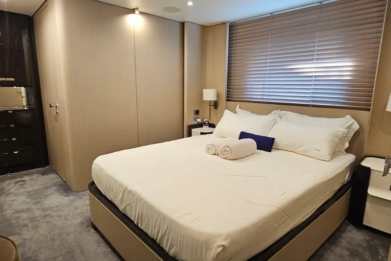 Yacht Photos Pics Luxurious bedroom interior on 2022 Azimut Grande 32 Metri yacht, featuring elegant design and cozy ambiance.
