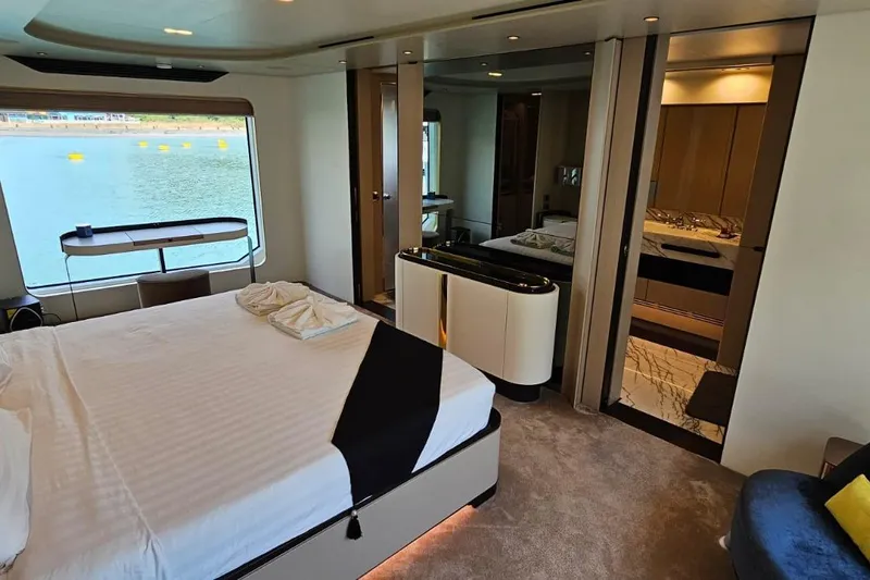  Yacht Photos Pics Luxurious bedroom interior of 2022 Azimut Grande 32 Metri yacht with waterfront view.